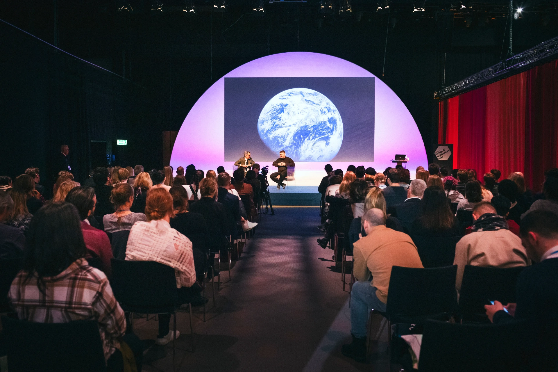 Audience watching a keynote on a large stage at a corporate conference in Stockholm