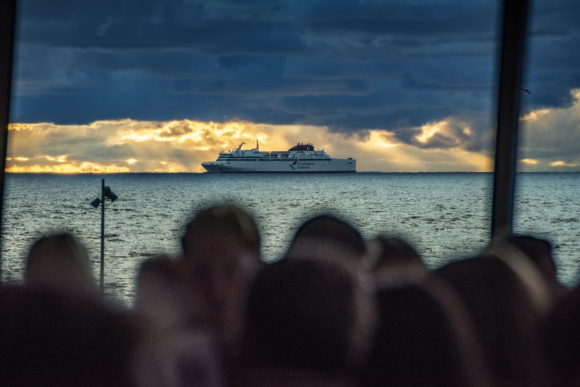 Destination Gotland ferry approaching Visby at sunset, seen from inside the coach