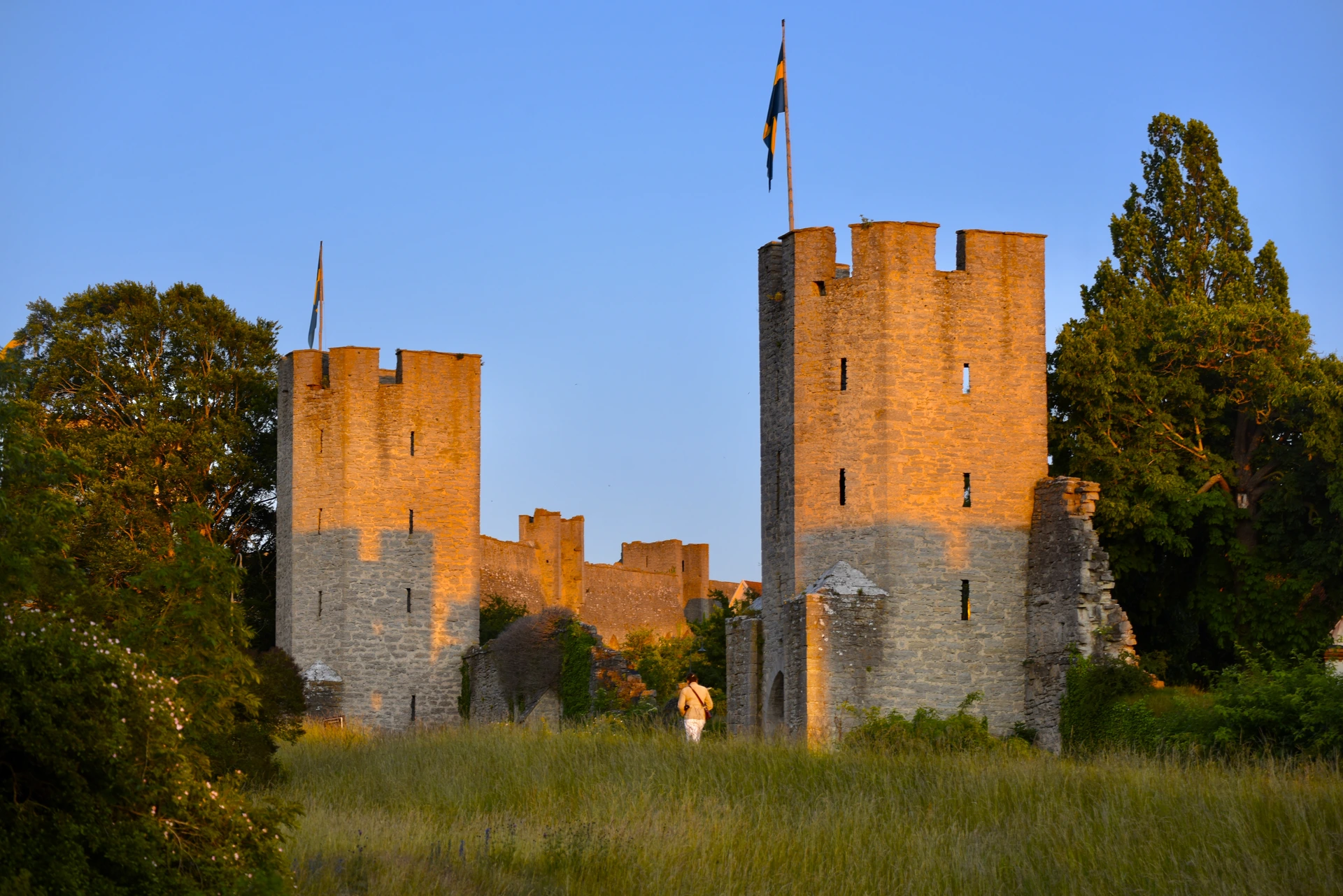 Visby's medieval twin towers glowing in golden hour light